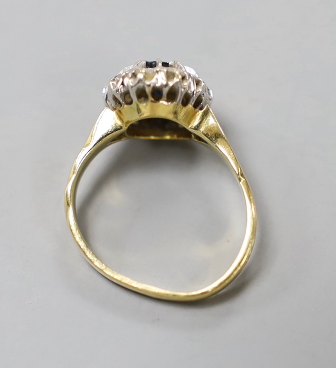 A modern 18ct gold, sapphire and diamond set oval cluster ring, size L, gross weight 4.6 grams.